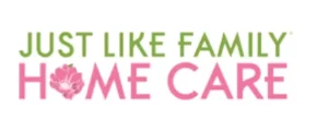 Logo for 'Just Like Family Home Care' featuring the text in green and pink colors, alongside a floral icon, representing a caregiving service.