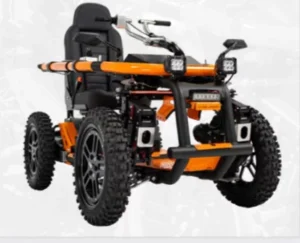 An all-terrain wheelchair displayed on a neutral background, featuring large black wheels, a sturdy orange frame, and front lights. The seat is designed for comfort and stability.