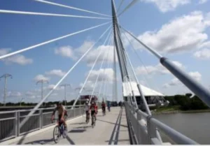 A close up of a bridge while some cyclists crossing the bridge