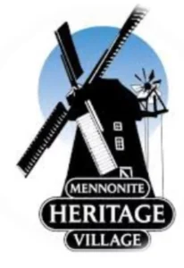 Logo of Mennonite Heritage Village featuring a traditional windmill against a blue circle background, with the text 'Mennonite Heritage Village' displayed prominently at the bottom.
