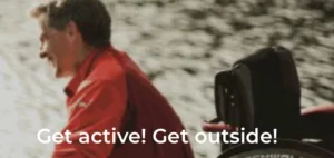 A man smiling while sitting next to a red bicycle by a body of water, with trees in the background. The image features motivational text encouraging outdoor activity.