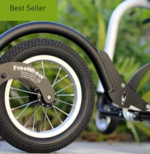 A close-up of a bicycle wheel with a thick black tire and a white rim, showing part of the bicycle frame in the background, alongside green foliage. A green label in the corner reads 'Best Seller'.