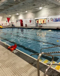 A spacious indoor swimming pool filled with water