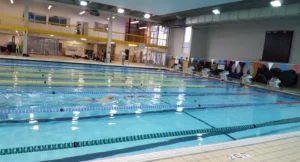 A spacious indoor swimming pool filled with water