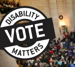 A large group of people gathered in a public space, symbolizing civic engagement. A circular design overlays the image with the text 'DISABILITY VOTE MATTERS' prominently displayed.