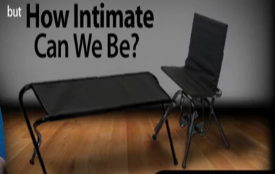 A black Intimacy Chair setup featuring two pieces: a flat pad and a seated chair, displayed on a wooden floor. The background features the text "How Intimate Can We Be?" in bold black letters.