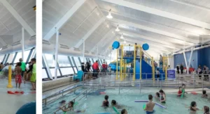 A spacious indoor swimming pool filled with water