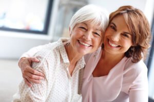 Female health care aide attending to an elderly women client