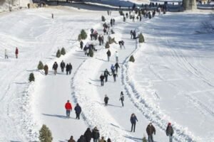 The forks, winter frozen river trail with people, skating cycling, walking, and wheelchair skating