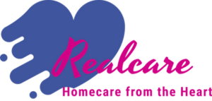 A logo featuring a blue heart shape with flowing paint splashes, and the word 'Realcare' in bold pink font, accompanied by the tagline 'Homecare from the Heart' in smaller pink font.