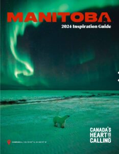 Cover of the 'Manitoba 2024 Inspiration Guide' featuring the northern lights over a snowy landscape, with a small polar bear figurine by the shore. Text reads 'MANITOBA 2024 Inspiration Guide' and 'CANADA'S HEART IS CALLING'. Locations indicated are Churchill.