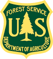 The logo of the U.S. Forest Service, featuring a green shield with a yellow outlined tree in the center, the letters 'U.S.' above it, and 'DEPARTMENT OF AGRICULTURE' below.