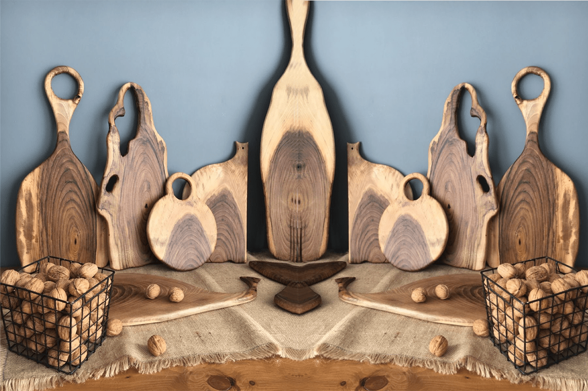 texcher-min A variety of wooden cutting boards and kitchen items arranged together on a countertop.