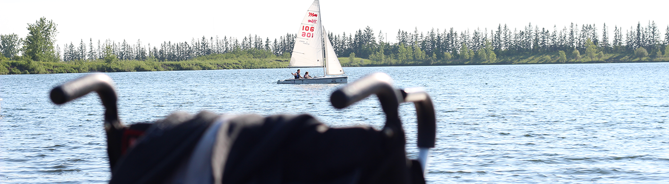 Two people in a boat with an IOS sign, floating on a calm lake.