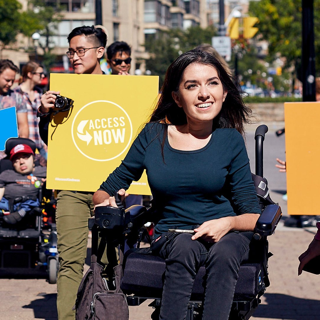 Wheelchair disability advocate is sitting in a wheelchair at a protest for better accessibility in airplanes
