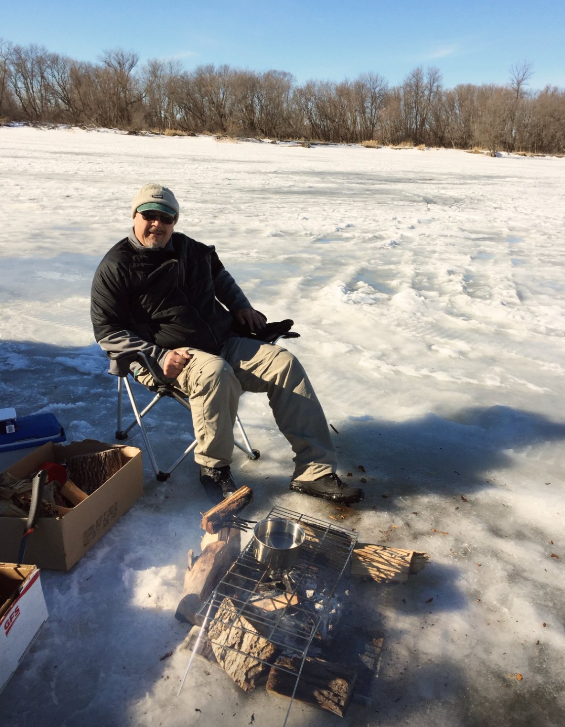 A man in a chair, displaying a relaxed posture while observing his surroundings.