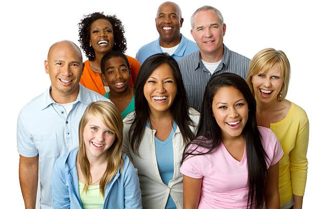 A cheerful group of individuals standing closely together, all smiling and enjoying each other's company.
