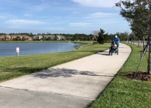 Cycling trail beside the lake and adaptive cycle is travelling a lot of peeved to pass