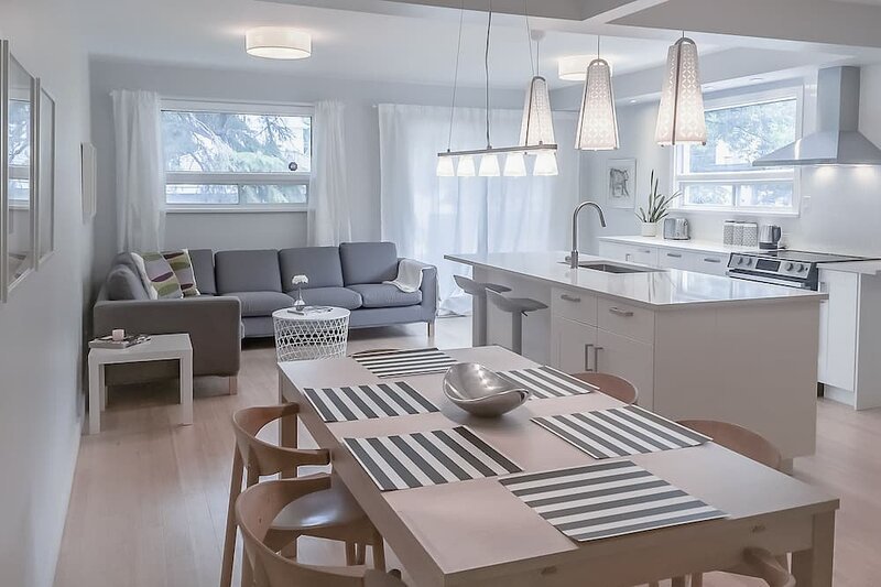 So the inside of a luxury condominium, living room, spacious windows, light, brown, elegant furniture