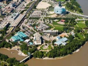 Overhead drone image of the forks, showing part of the river, a couple bridges with the buildings that make up the forks