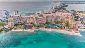 Huge resort, hotel against Aqua blue green waters coast of Mexico