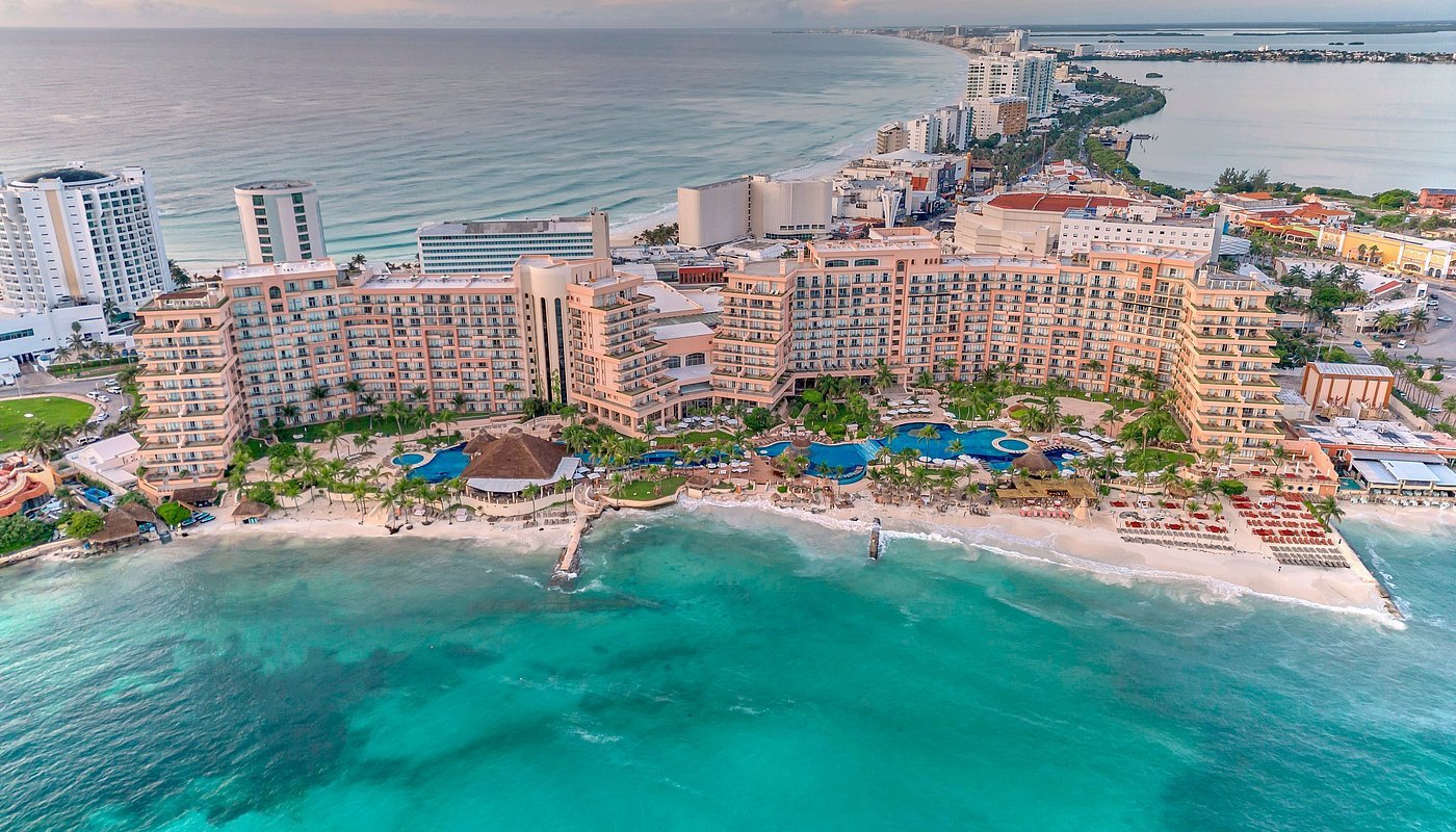Huge resort, hotel against Aqua blue green waters coast of Mexico
