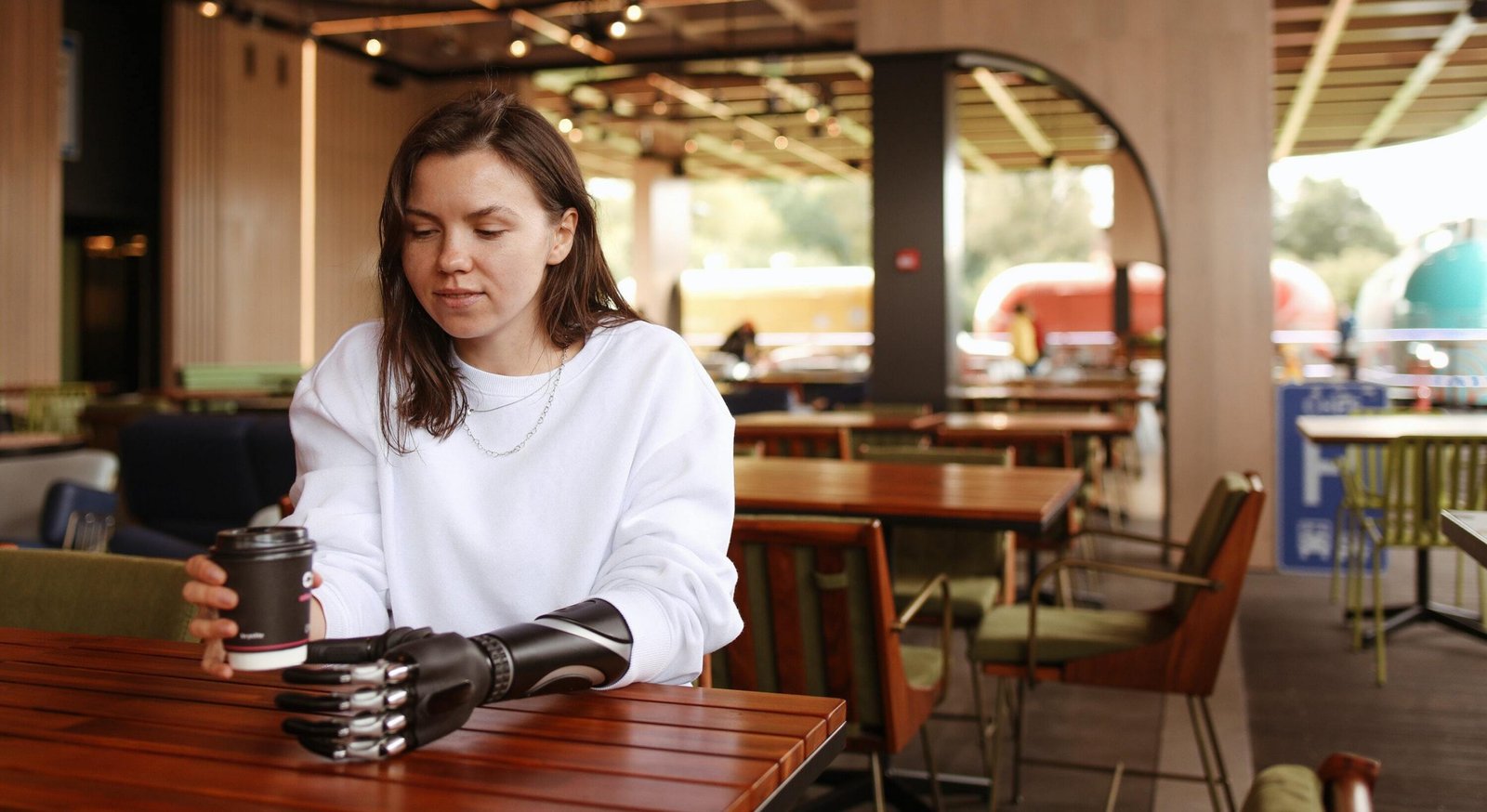 Women sitting out at a table in a restaurant using her phone apps to find information
