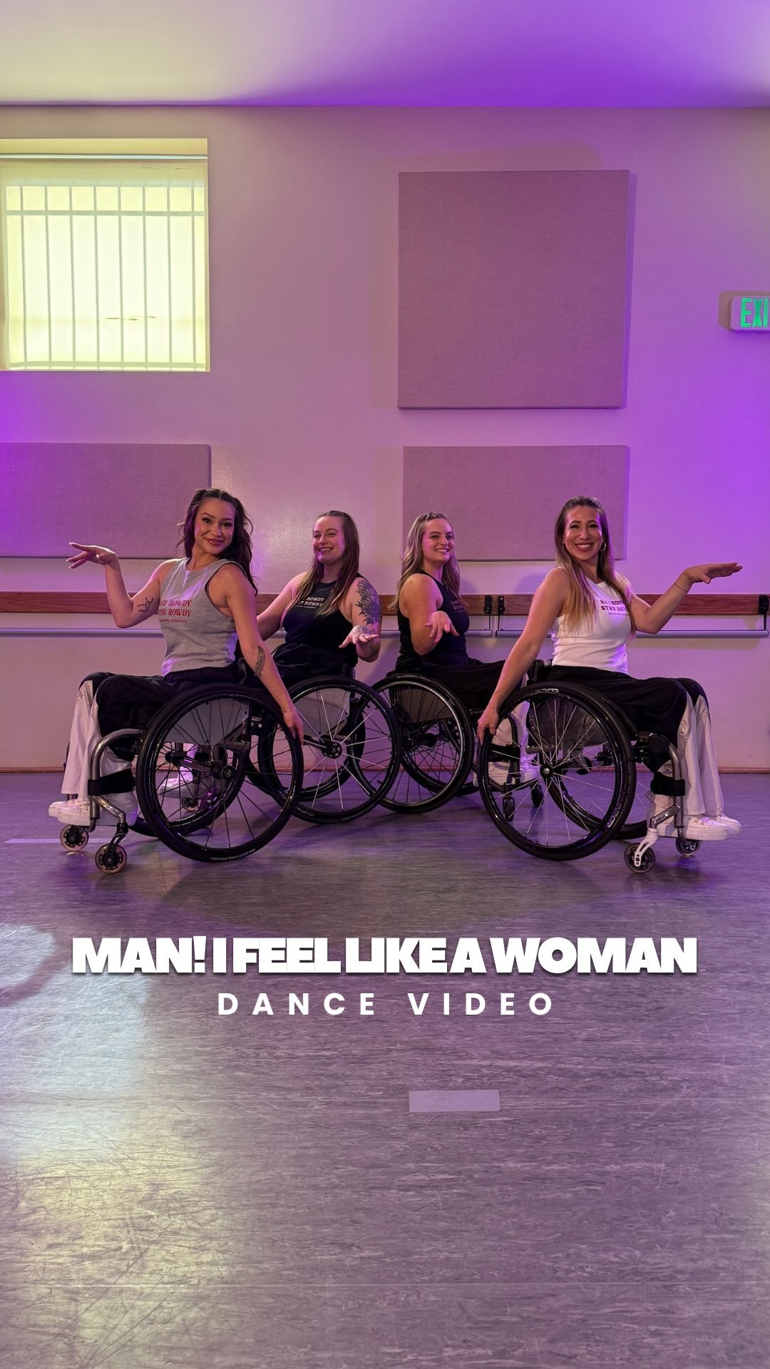 Four ladies in wheelchairs part of a dance team on the dance floor set against the purple lit up background