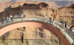 People walking on an accessible glass bottom overlook over the grand canyon