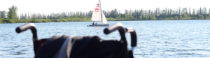 Two people in a boat with an IOS sign, floating on a calm lake.