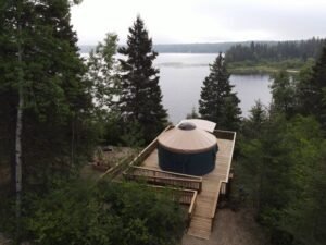 A scenic spot at the shore of the lake with a pavilion surrounded by lush trees.