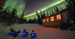 people watching northern lights and aurora house and forest